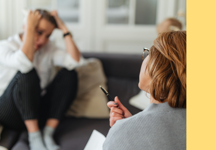 Therapist makes calming gesture towards distressed parent